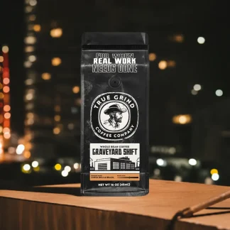 Bag of Graveyard Shift coffee featured in a night construction scene.